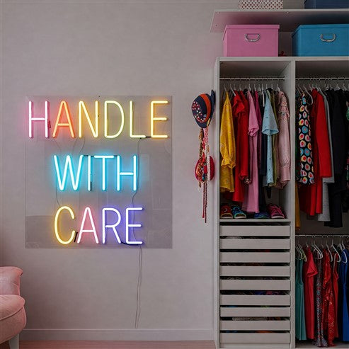 Children's room decorated with a pink neon sign reading 'Tiny But Mighty,' adding a playful and vibrant touch to the space while inspiring personality and charm