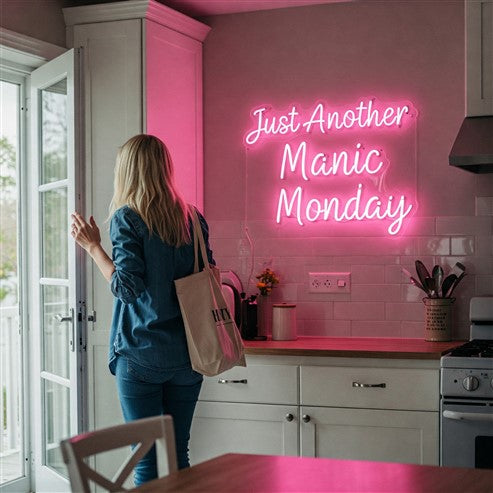 Bright kitchen featuring a pink neon sign reading 'Just Another Manic Monday,' adding a playful and energetic vibe to the modern space