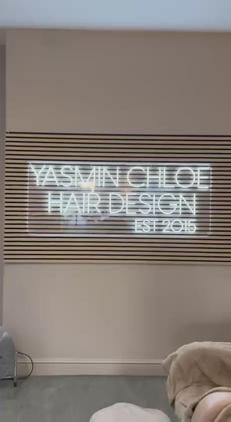 Neon light signs in warm white script on living room wall, custom neon wall art by Neon Now UK